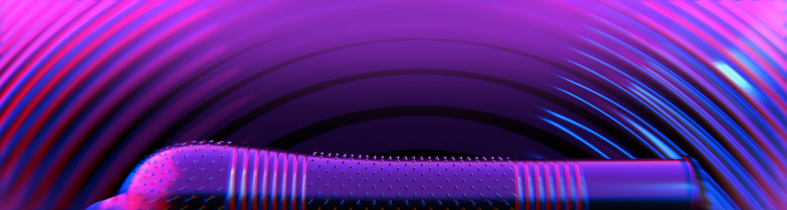 A close-up of a textured Pasanet Intensity condom, shown against a dark background with swirling purple, pink, and blue light effects.
