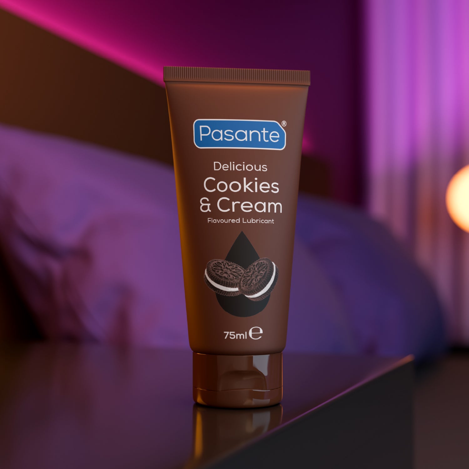 Tube of Pasante Delicious Cookies & Cream flavored lubricant on a reflective surface with a blurred background.
